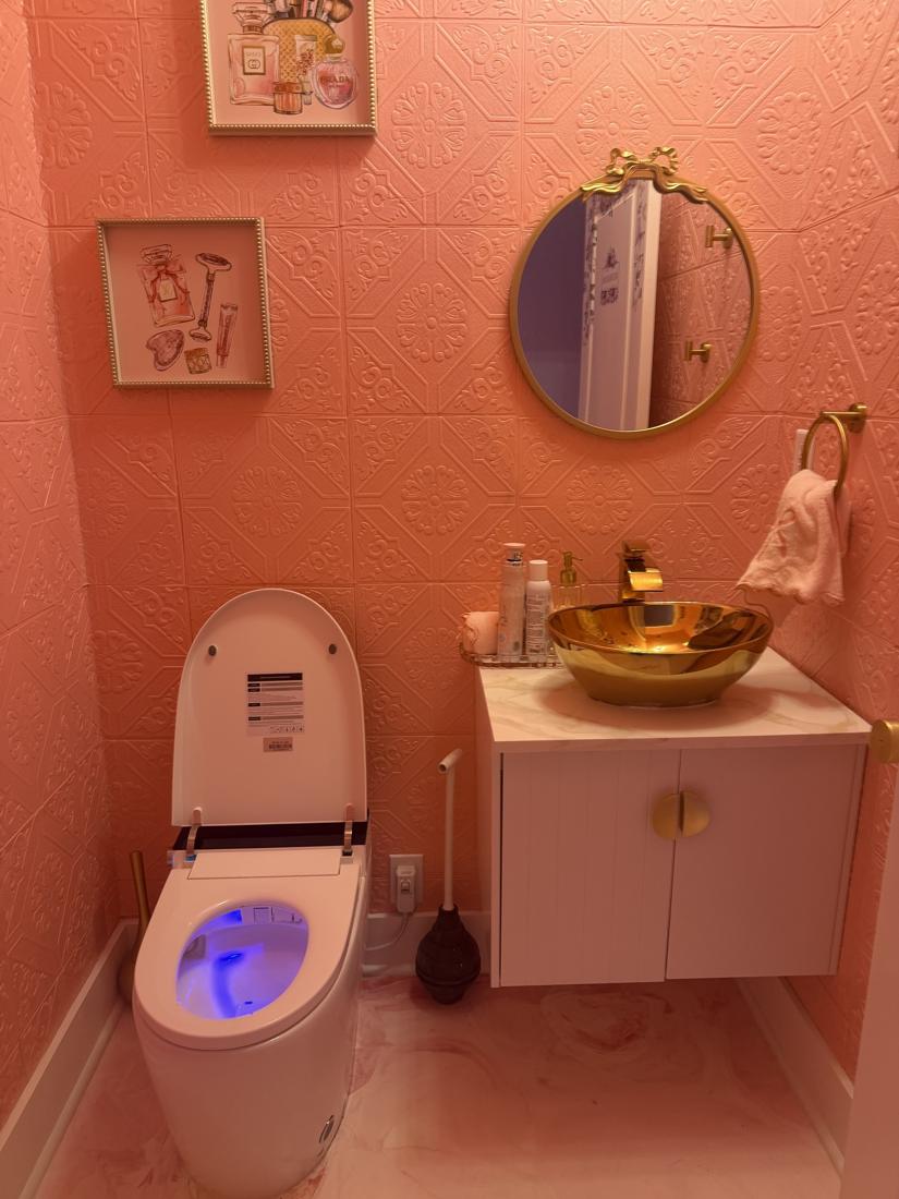 Gold vessel sink, round mirror and smart toilet